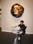 Айдан Салахова на фоне произведения Елены Берг на стенде Айдан Галереи